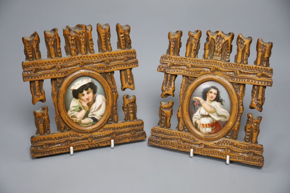 A pair of oval porcelain miniatures in carved frames, late 19th century, total height 17.5cm